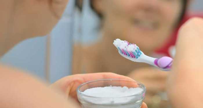 Brushing teeth with baking soda